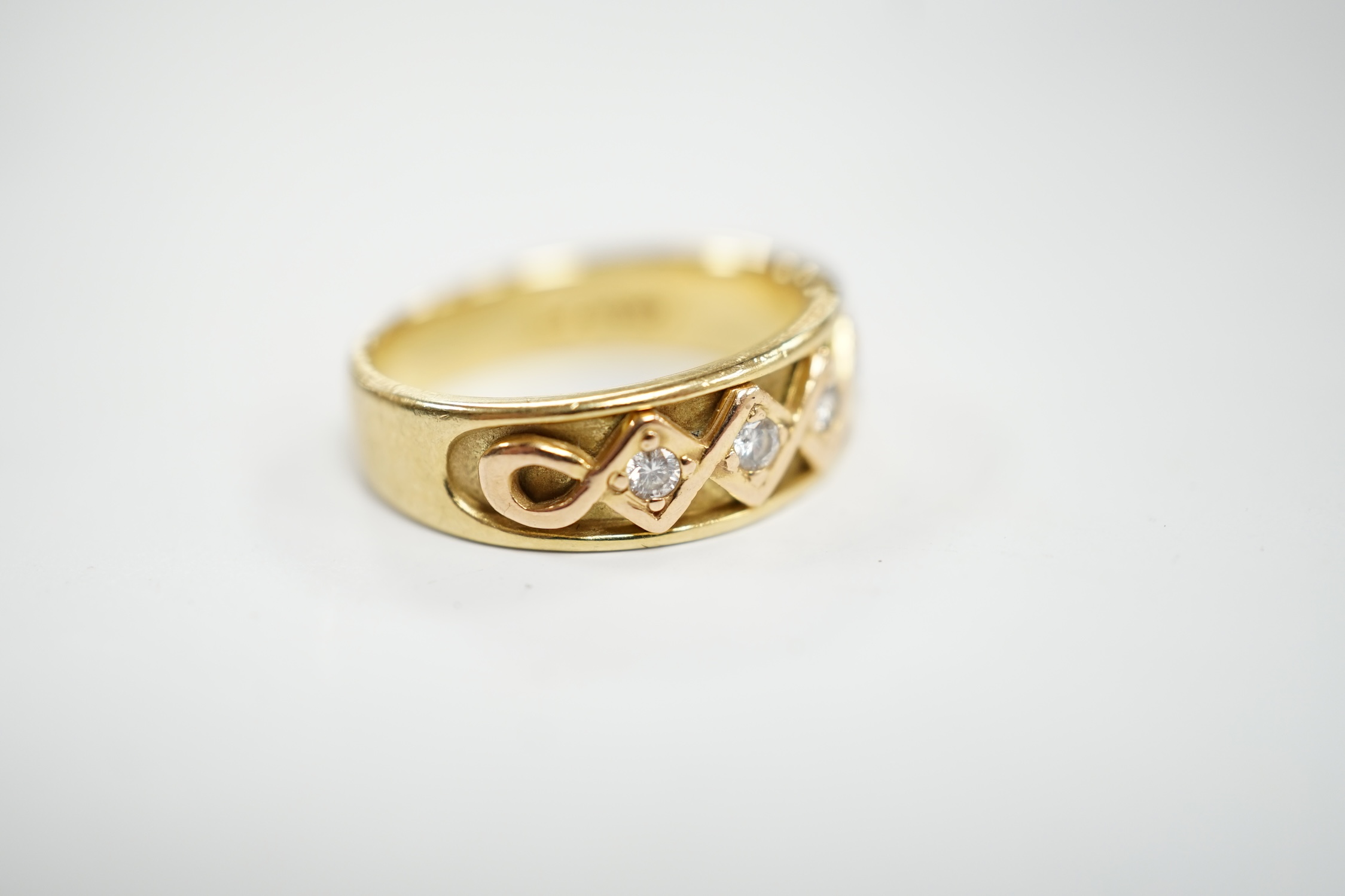 A modern 18ct gold and five stone diamond set half hoop ring, size O, gross weight 6.2 grams.